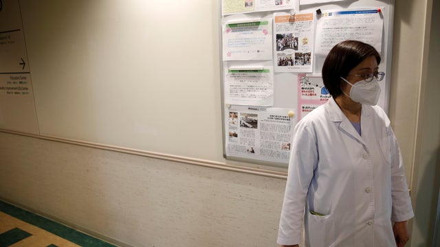 Fumie Sakamoto, a nurse of St. Luke's International Hospital stands in front of her office as she talks to Reuters reporters in Tokyo 