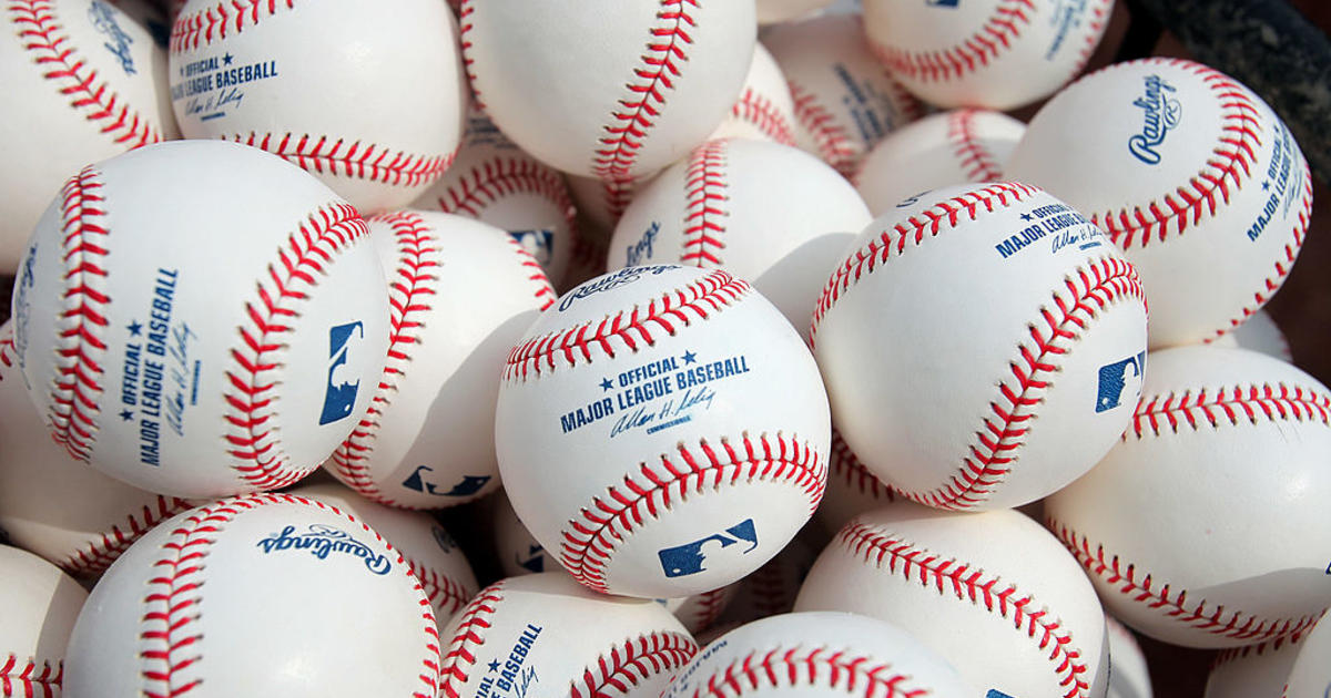An Official Rawlings Major League baseball sits with a glove, lock News  Photo - Getty Images