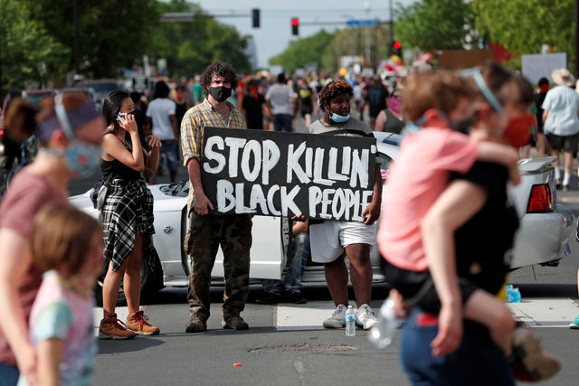 Protesters gather at the scene where Floyd was pinned down by a police officer in Minneapolis