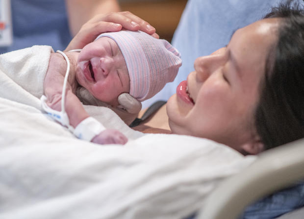 Asian Mother Having Skin-To-Skin Time in the Delivery Room stock photo 