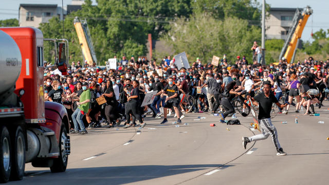 Tanker truck drives into protesters on bridge 