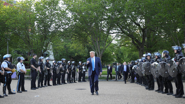 President Trump walks between lines of riot police in Washington, D.C. 