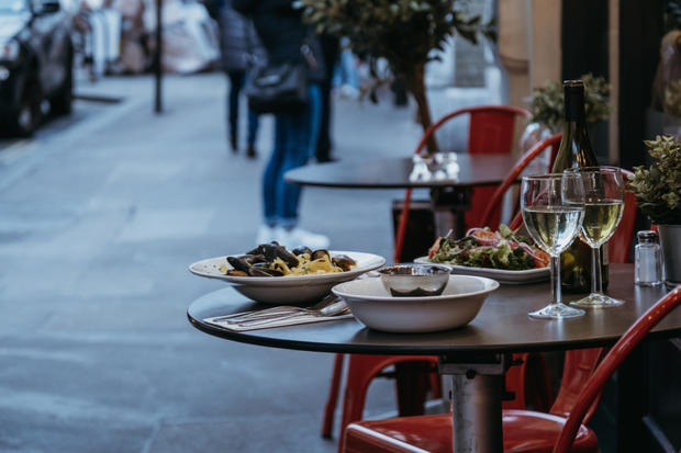 Food and wine on the outdoor table of a restaurant, selective focus. 