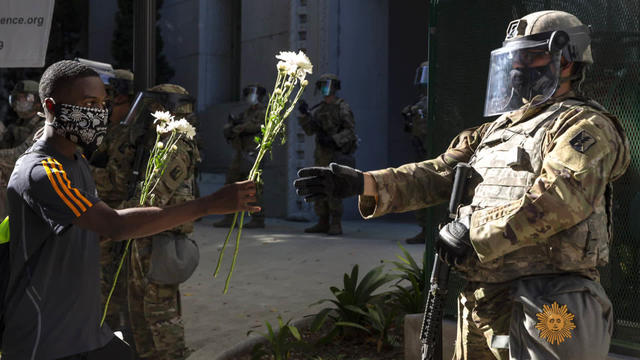 hartman-protester-giving-flowers-1920-496101-640x360.jpg 