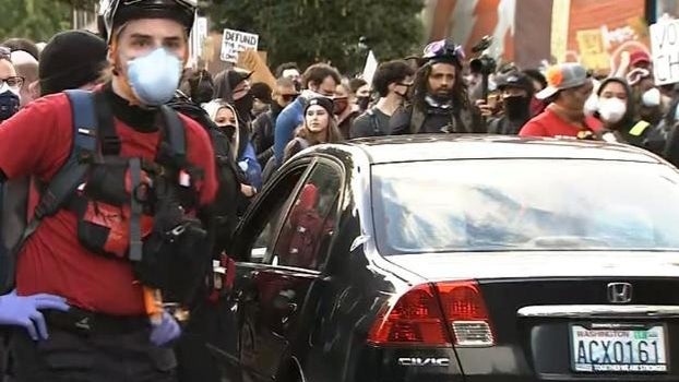 car-is-surrounded-by-grorge-floyd-protesters-in-seattle-shortly-after-it-was-driven-toward-them-on-060720.jpg 