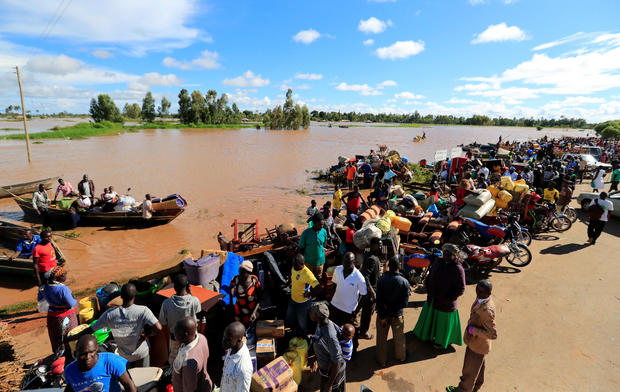 Residents gather with their belongings after their homes were flooded, as River Nzoia burst its banks due to heavy rainfall and the backflow from Lake Victoria, in Budalangi within Busia County 