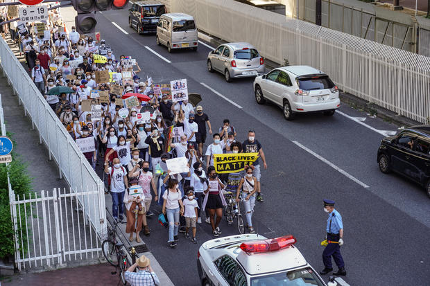 Protesters march with placards during the demonstration. 