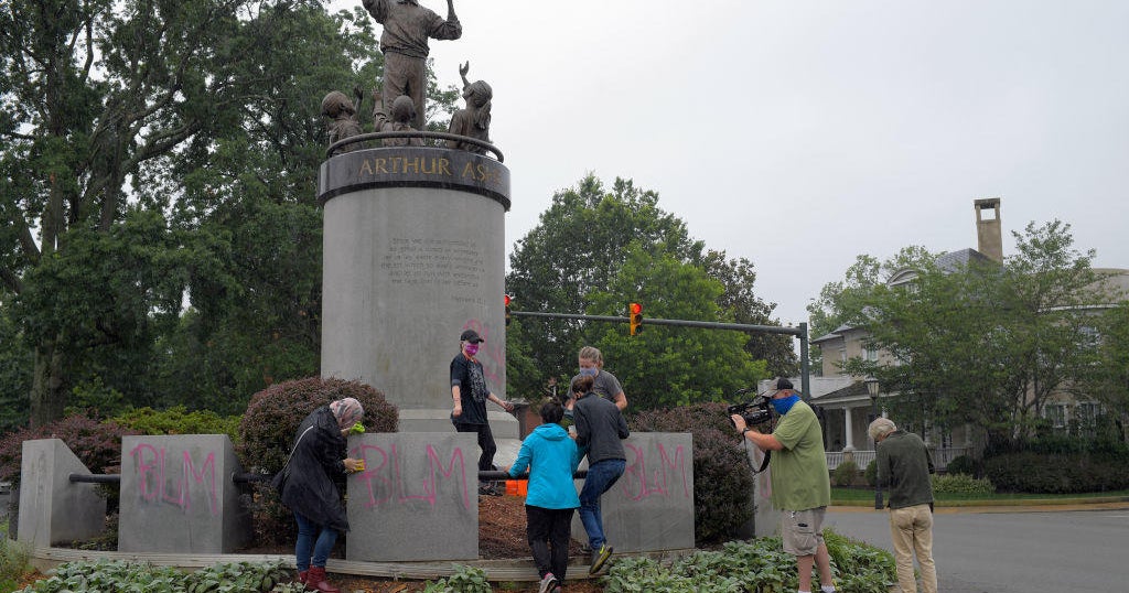 "White Lives Matter" spraypainted across Arthur Ashe statue in