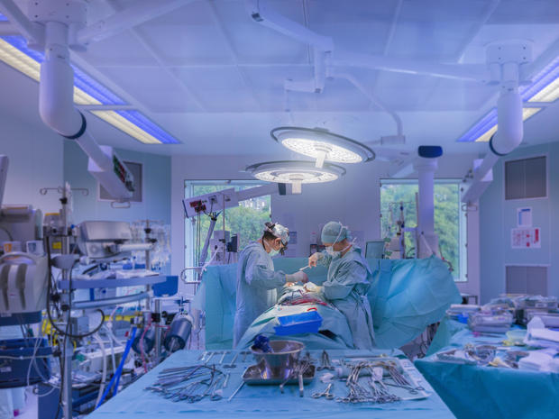 Surgeons performing open heart surgery 