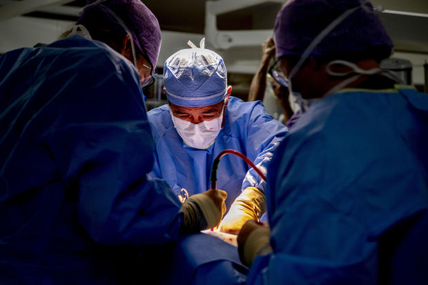 Doctors doing an operation on a broken leg in the surgery 