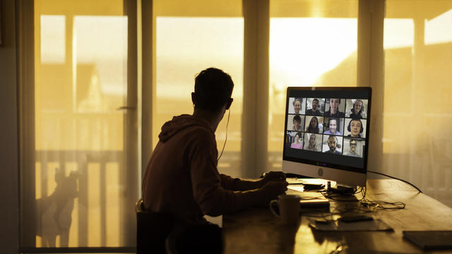 Young man distracted while on  video call from his home during lockdown 