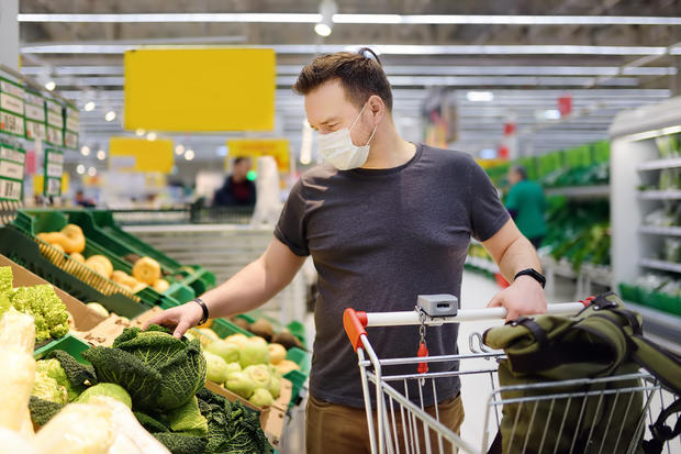 face mask Man wearing disposable medical mask shopping in supermarket during coronavirus pneumonia outbreak 