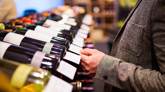 graphicstock-unrecognizable-young-man-in-a-wine-shop-choosing-a-wine_SR9HrFTZW.jpg 