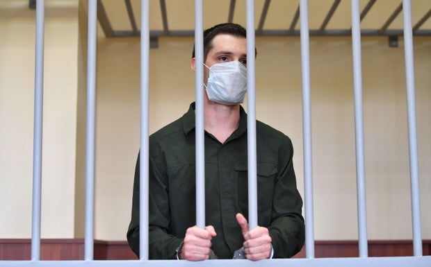 Trevor Reed, charged with attacking police, stands inside a defendants' cage during his verdict hearing at Moscow's Golovinsky district court on July 30, 2020.