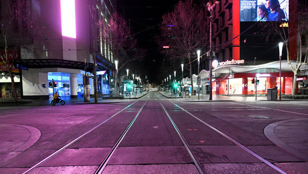 An empty street is seen after a citywide curfew was introduced to slow the spread of COVID-19 in Melbourne 