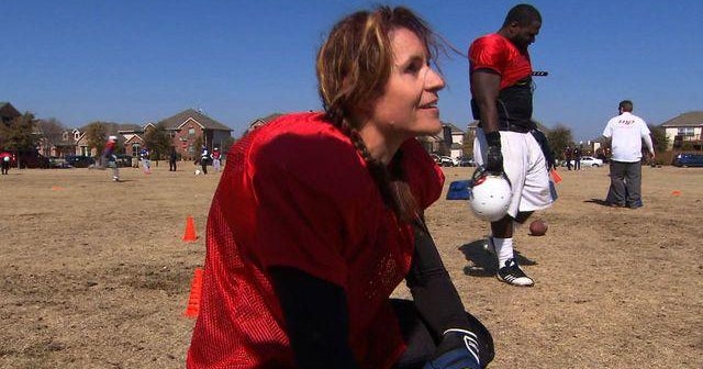 Woman breaks record as first pro-football player - CBS News