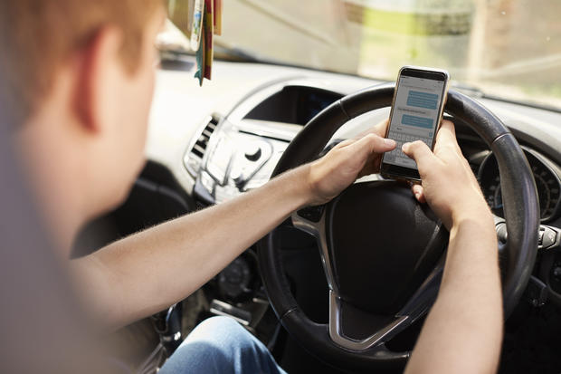 Young Man cellphone Text Message Whilst Driving 