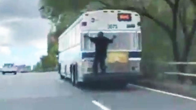 Man-Holds-On-To-Bus.jpg 