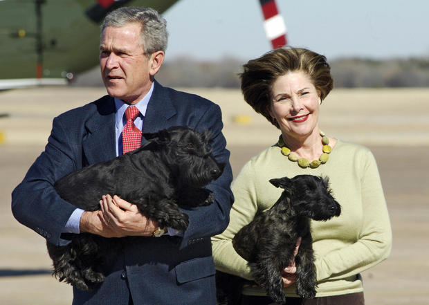 US President George W. Bush carries his 