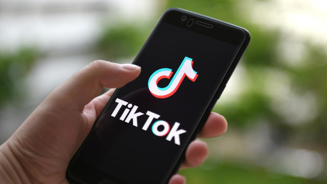 In this photo illustration a TikTok logo displayed on a 