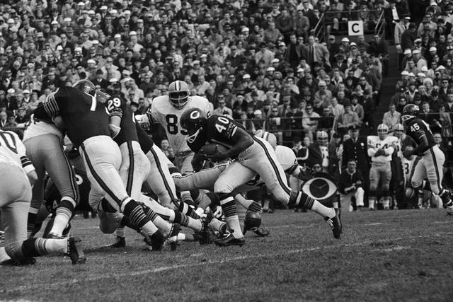 Running backs Gale Sayers and Brian Piccolo of the Chicago Bears 1960s.  Sayers and Piccolo were the first black and white teammates to room  together on the team and later became good