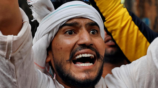 A demonstrator shouts slogans during a protest after the death of a rape victim, in New Delhi 