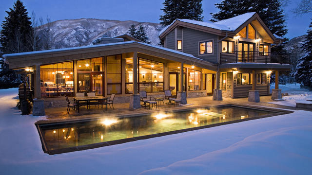 Exterior shot of lit contemporary home in winter. 