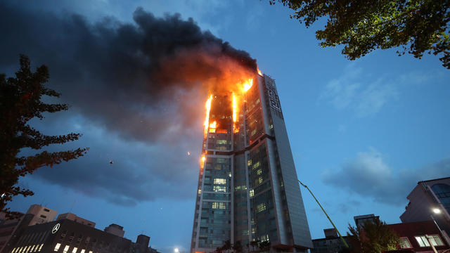 A mixed-use high-rise residential building is engulfed by a fire in Ulsan 