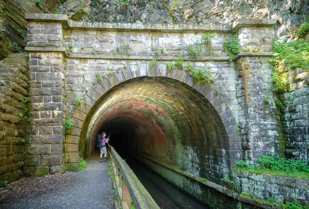 man with backpack in Paw Paw Tunnel C&O canal towpath 