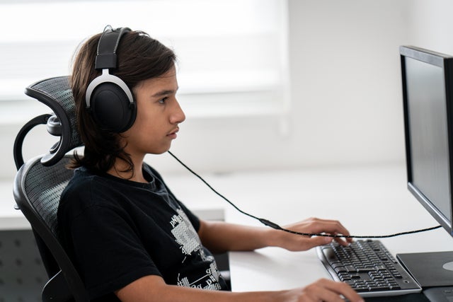 remote learning laptop school student Teenage boy sitting and working on computer distance learning