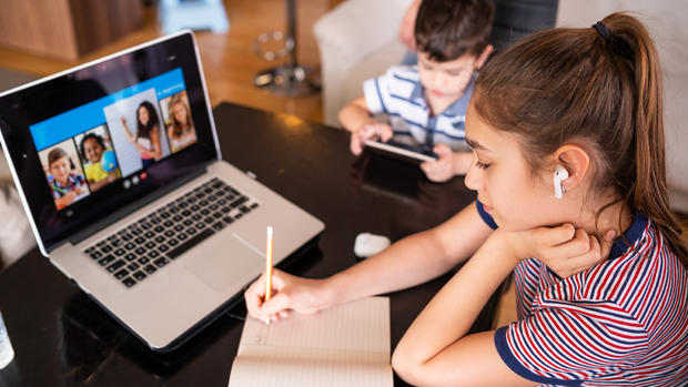 remote learning laptop school student Teenage girl studying with video online lesson at home   family in isolation Homeschooling and distance learning 