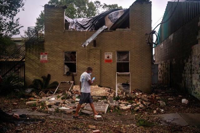 Joel Martinez, who until just recently lived in the lower apartment, makes a photo of Washington Gardens Apartments after it collapsed from the winds brought by Hurricane Zeta in New Orleans, Louisiana, on October 28, 2020. 
