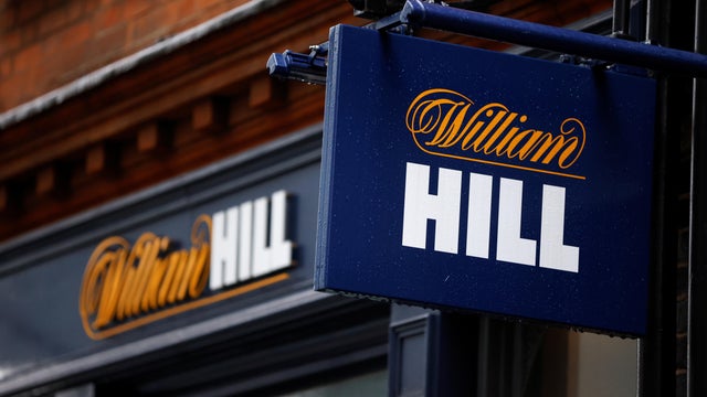 Signs are seen outside a branch of bookmaker William Hill in central London 