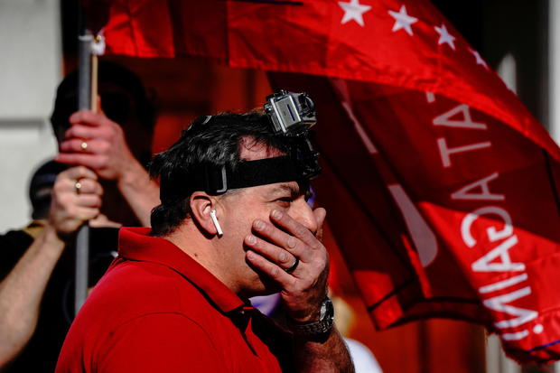 A supporter of U.S. President Donald Trump wearing a Go-Pro camera reacts in Madison 