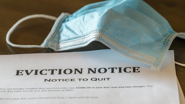 Official legal eviction order or notice to renter or tenant of home with face mask