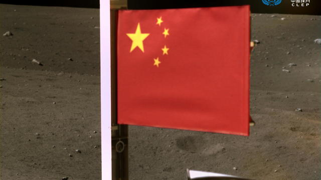 Handout image of China's national flag unfurled from the Chang'e-5 spacecraft 