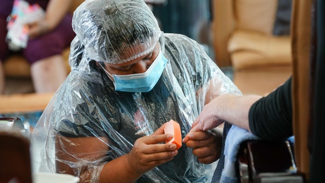 Nail salon worker in PPE 