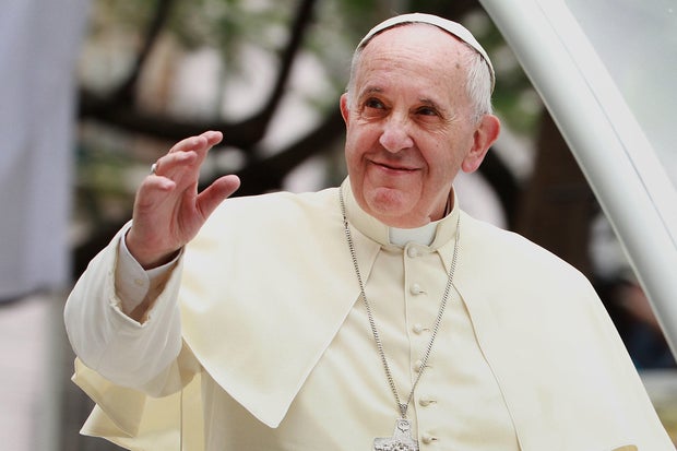 Pope Francis waves to thousands of followers as he arrives at the Manila Cathedral on Jan. 16, 2015, in Manila, Philippines. 