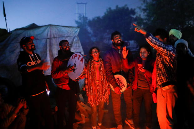 People sing as they gather to celebrate the arrival of the new year at the site of a protest against the newly passed farm bills at Singhu border near New Delhi 