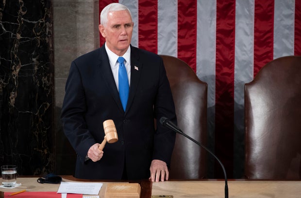 Vice President Mike Pence officiates as a joint session of the House and Senate convenes to confirm the Electoral College votes cast in November's election at the Capitol in Washington on Jan. 6, 2021.