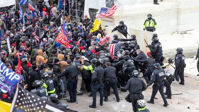 Pro-Trump protesters and police clash on top of the Capitol 