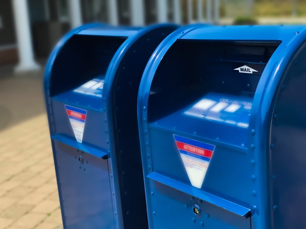 two traditional blue postal mailboxes post office blue box 