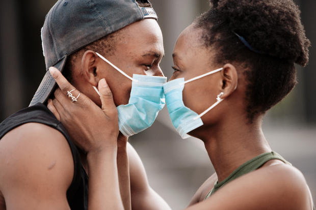 face mask dating Beautiful young couple wearing surgical face masks at close range 