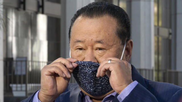 Che Ahn, Harvest Rock's senior pastor, adjusts his face mask before a news conference outside the Harvest Rock Church in Pasadena, California, February 7, 2021. 