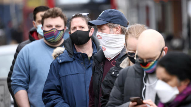 People wait in line for a COVID-19 swab test after a new coronavirus variant originating from South Africa was discovered, in Ealing, West London, February 2, 2021. 