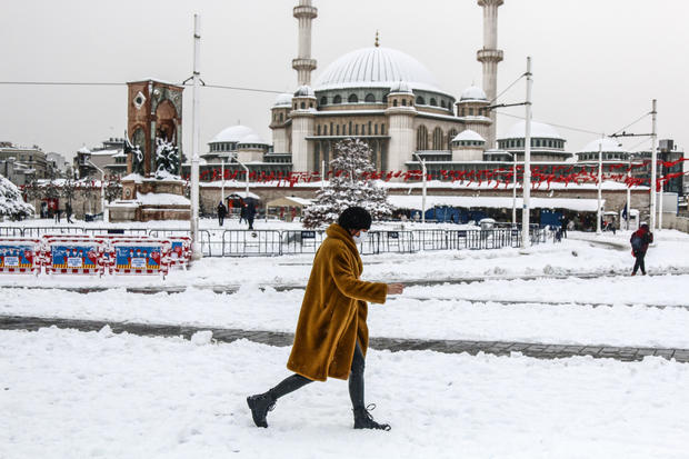 A woman walking along the snow-covered road in Istanbul 