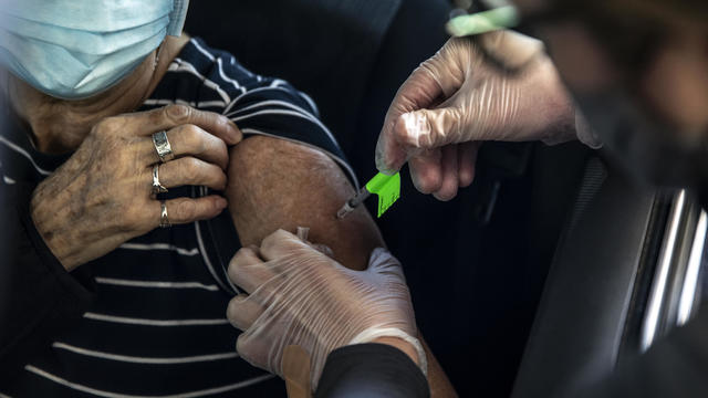 Residents Receive Covid-19 Vaccinations At Coors Field 