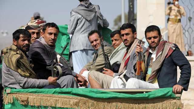 FILE PHOTO: Armed Houthi followers ride on the back of a truck after participating in a funeral of Houthi fighters killed in recent fighting against government forces in Yemen's oil-rich province of Marib, in Sanaa, Yemen 