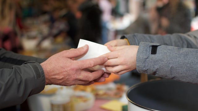 Cropped Image Of Volunteer Giving Food To Person 