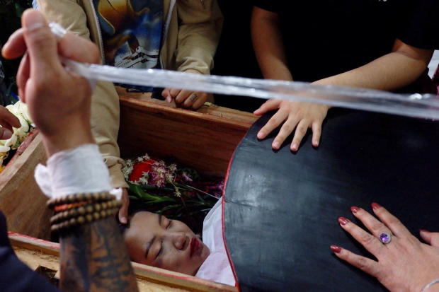The body of 19-year-old protester Angel lies during her funeral in Mandalay 